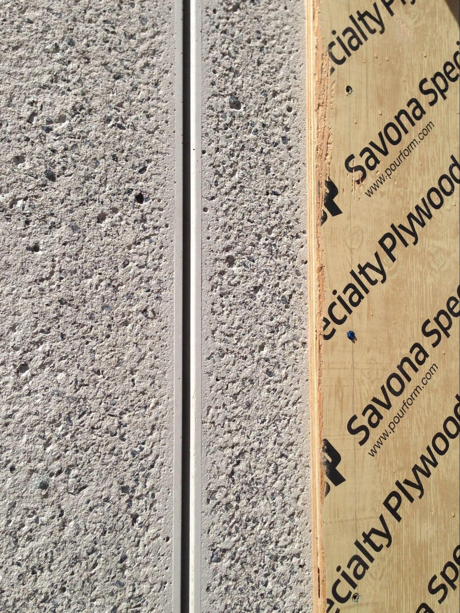 Close-up of concrete panels finished with rough texture.