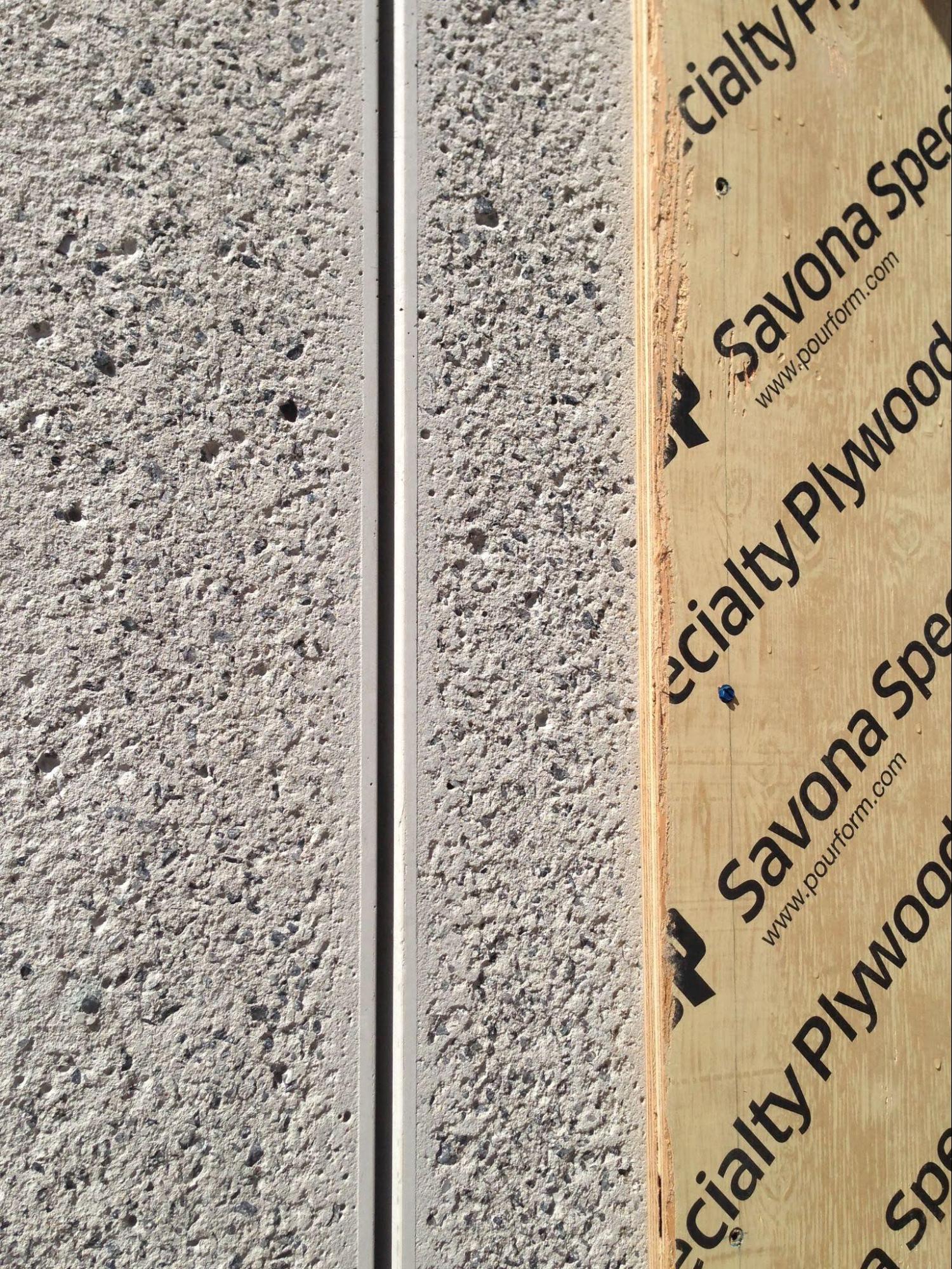Close-up of concrete panels finished with rough texture.