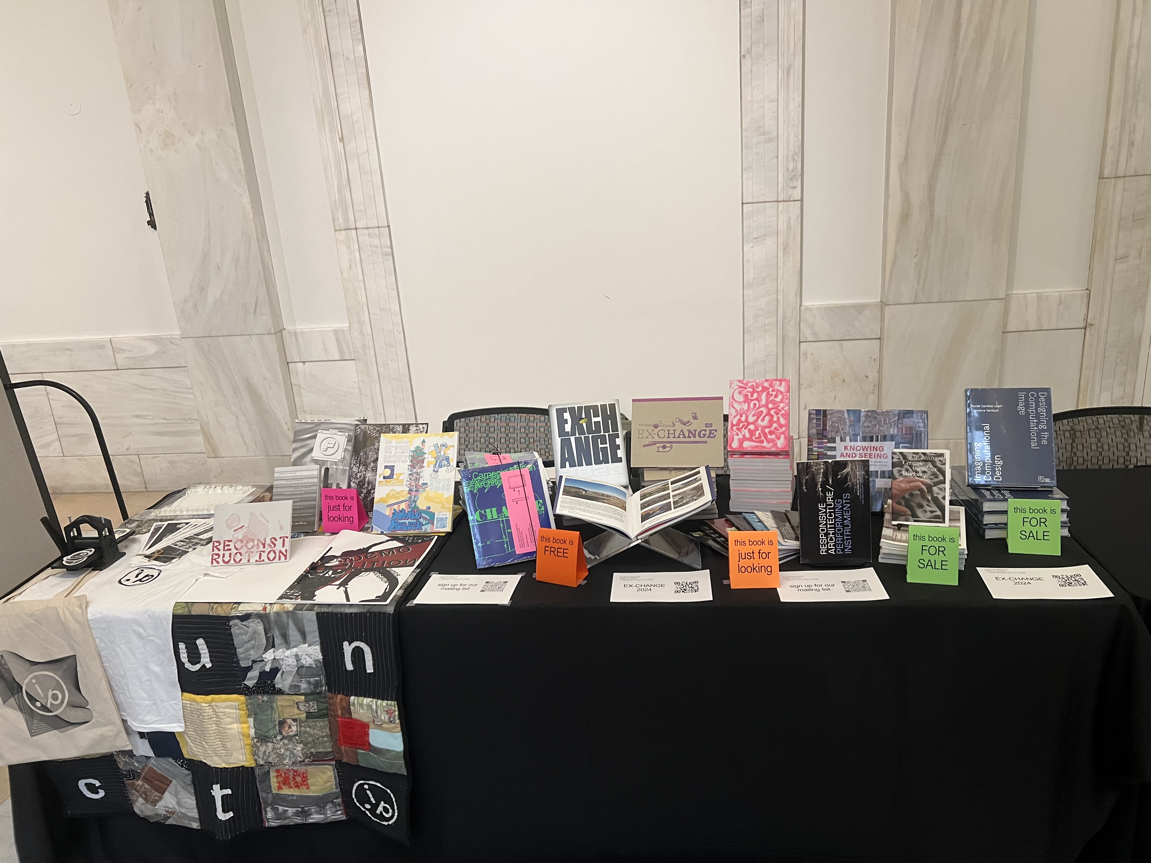 An exhibition table set up with publications on display from Carnegie Mellon Architecture.