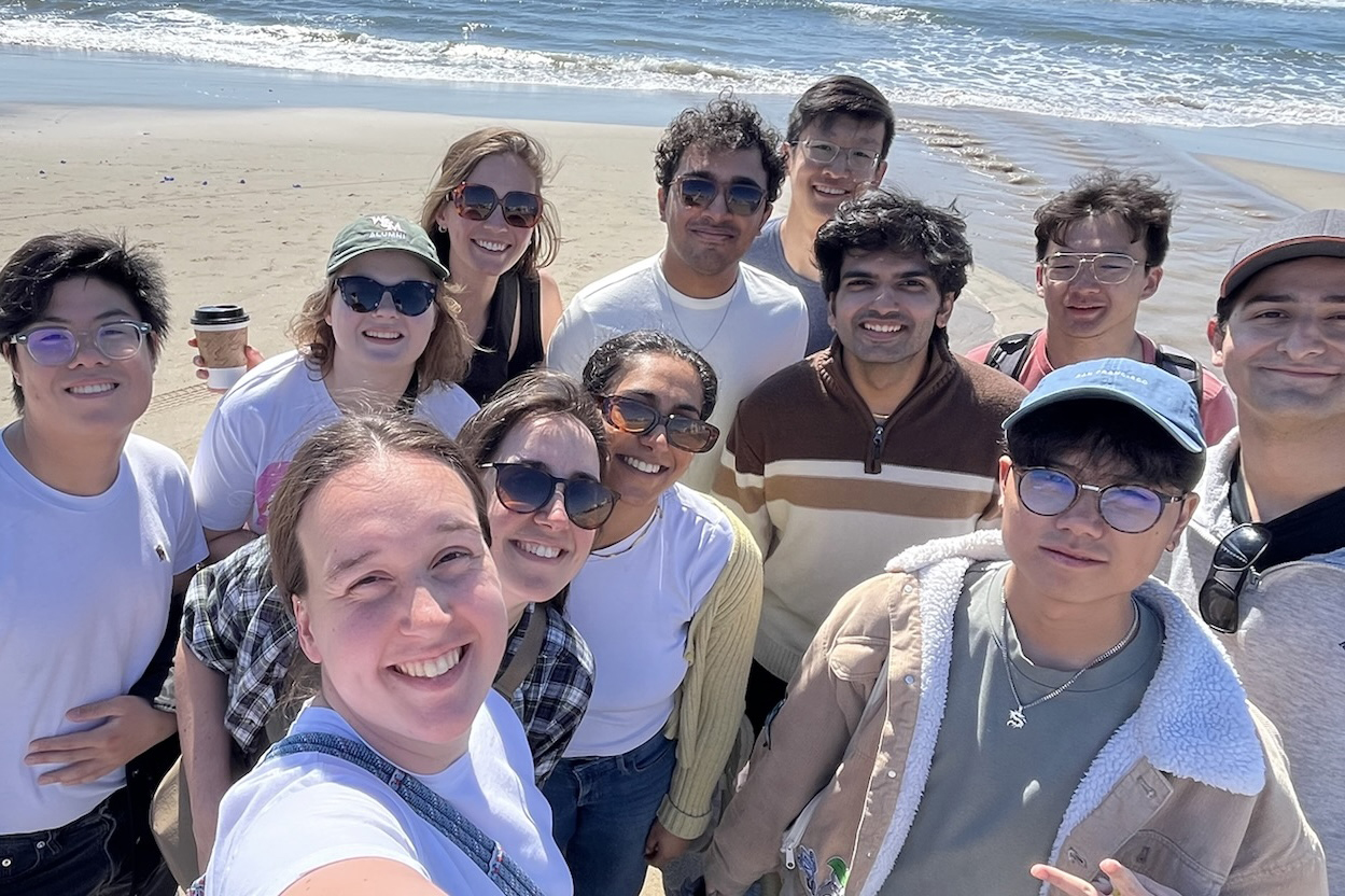 a group poses at the beach