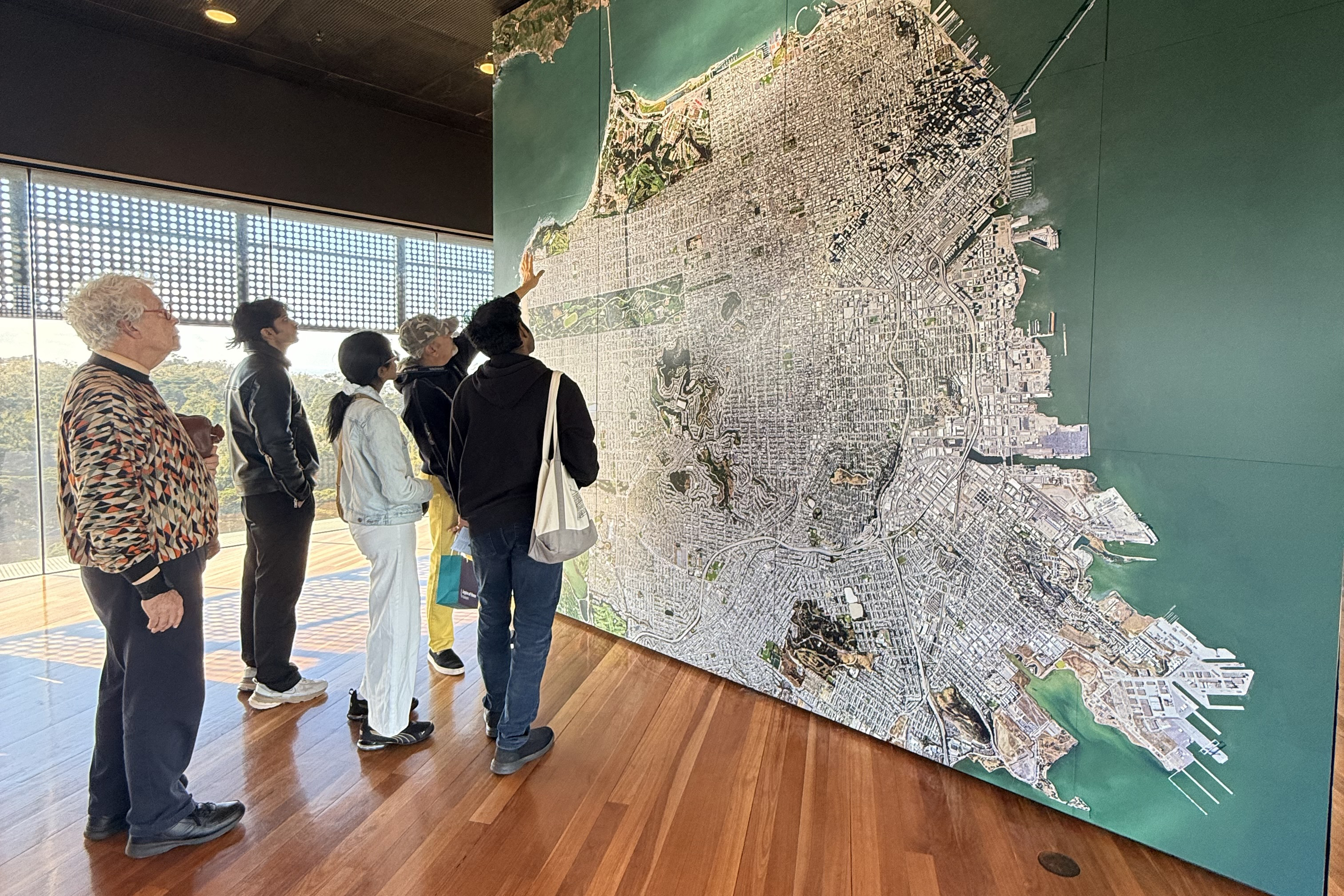 students gather around a large wall map of San Francisco