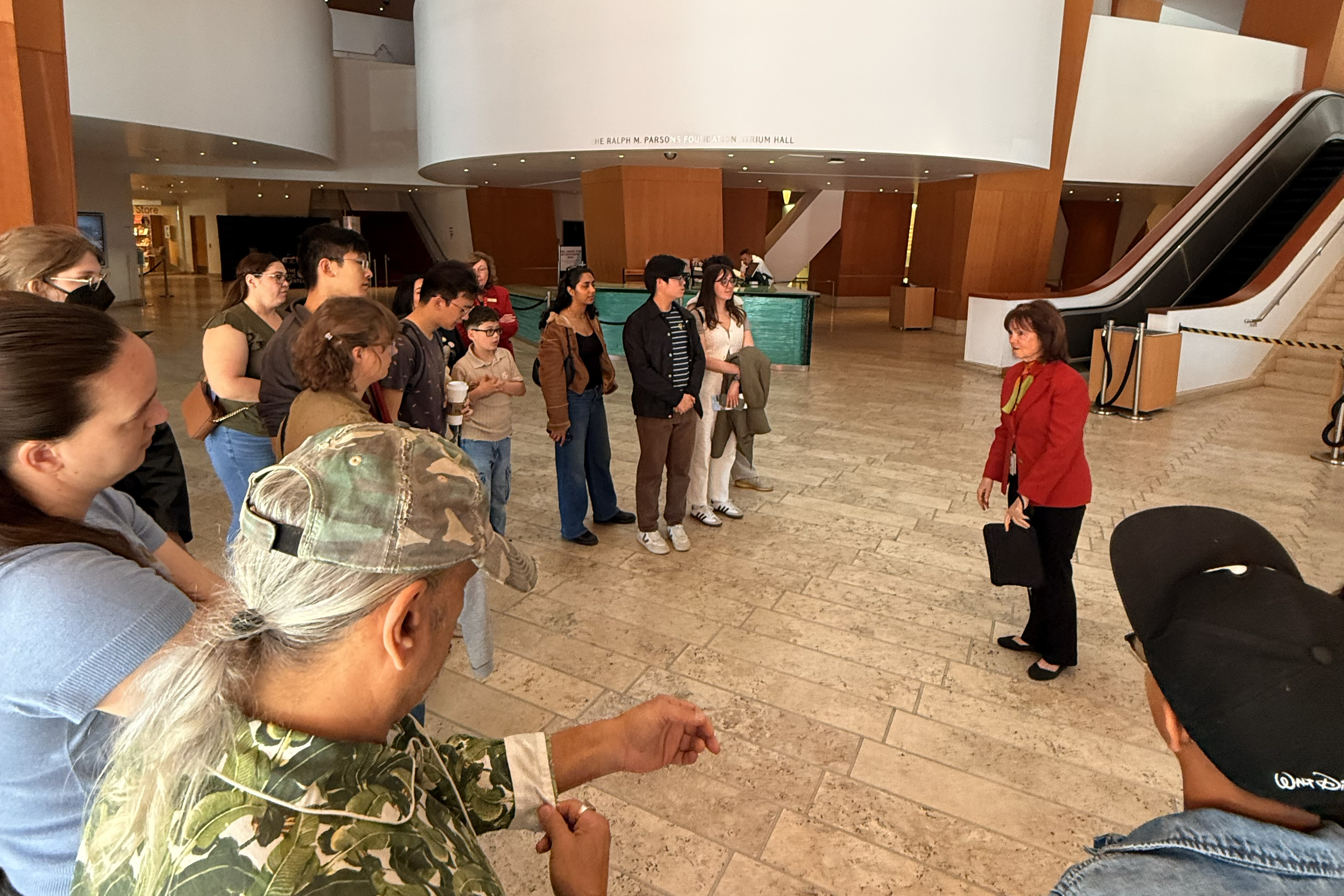 a group gathers for a tour in a theater lobby