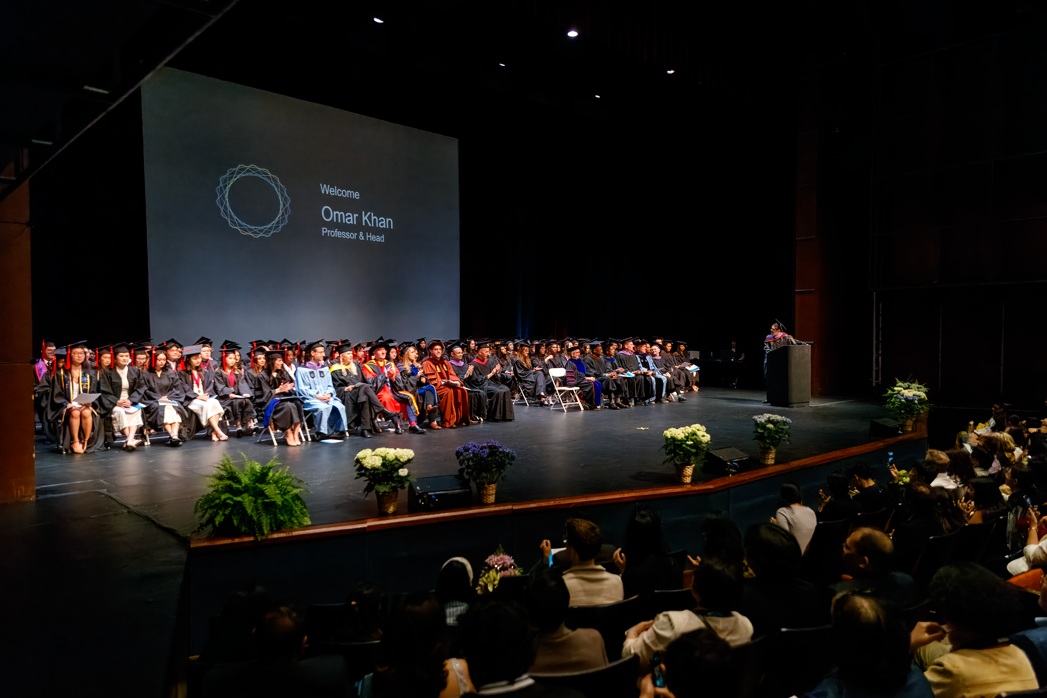 graduates process onstage