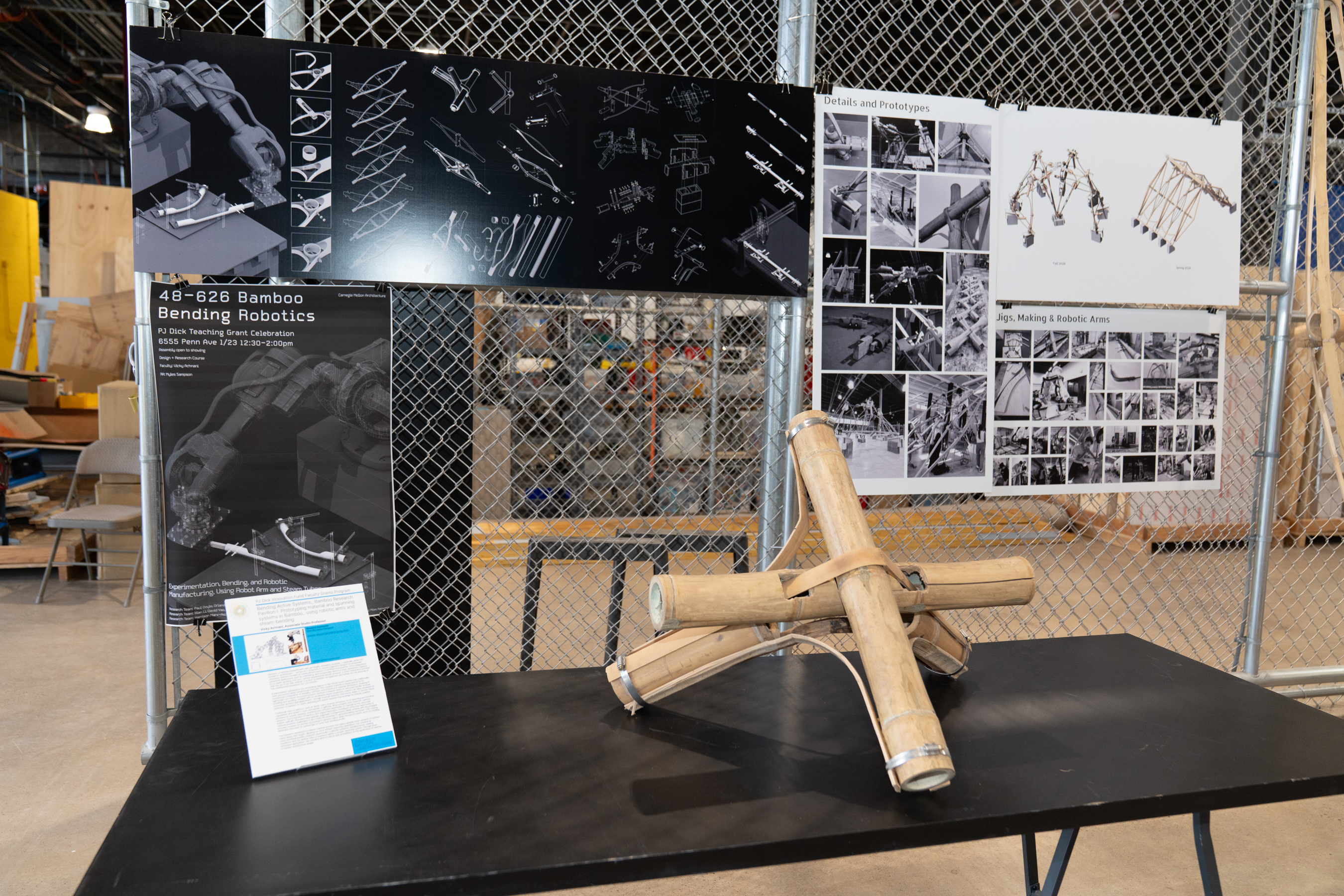 a table with pin-up displays and a large bamboo model.
