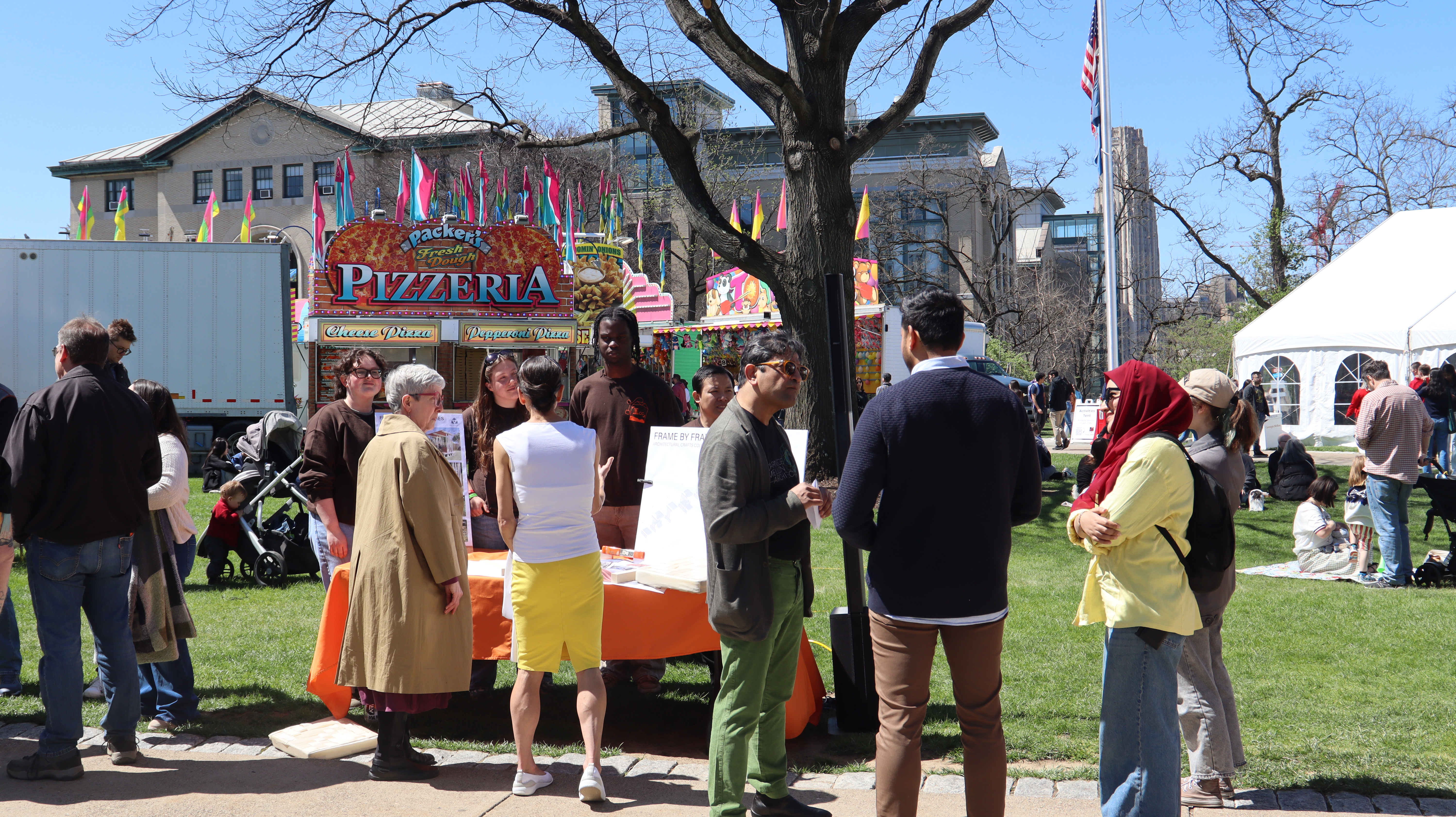 a group stands outside at spring carnival on a sunny day