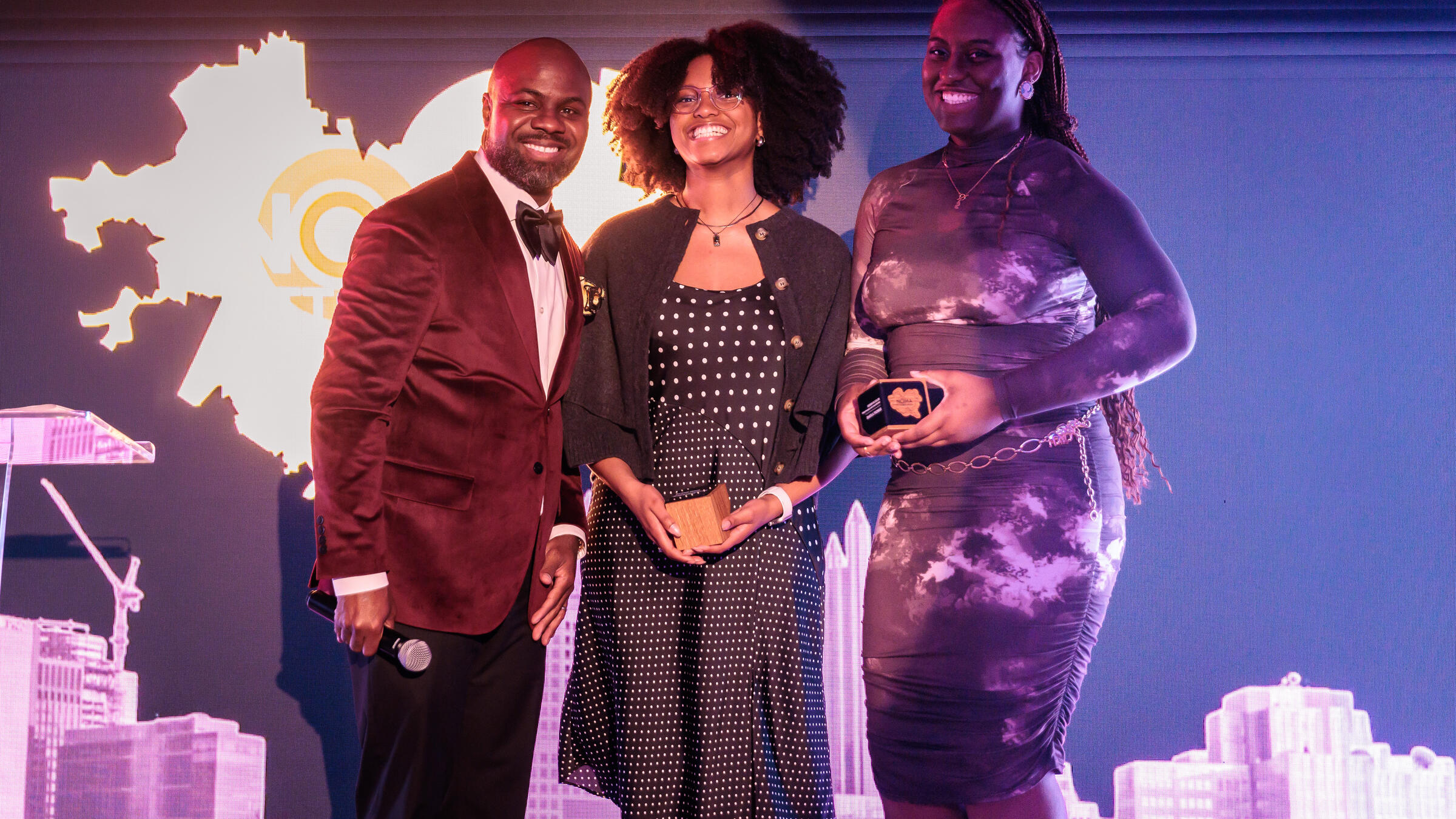Starr Wasler and Shayla Thomas receive awards onstage at NOMA gala