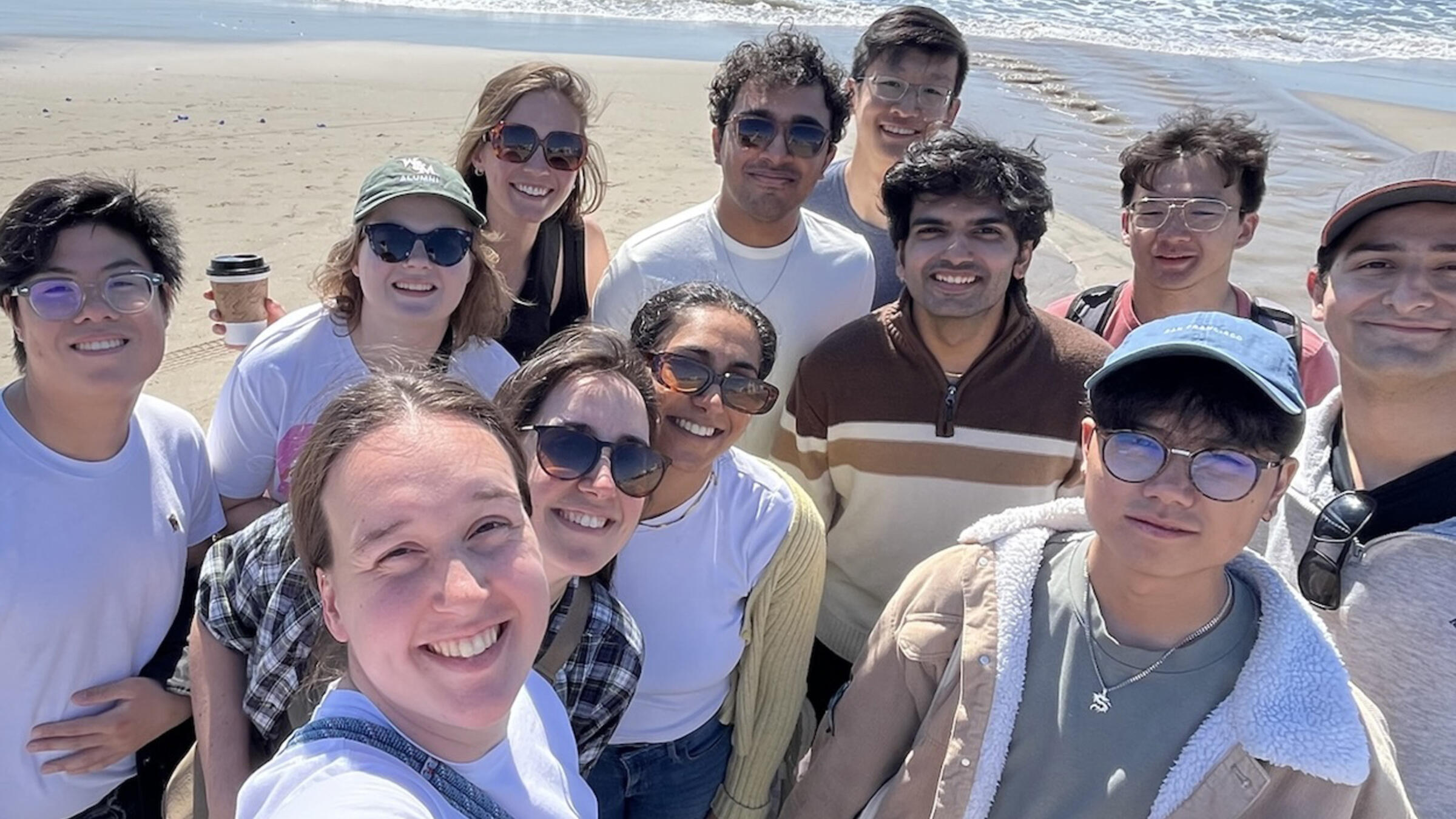 a group poses at the beach