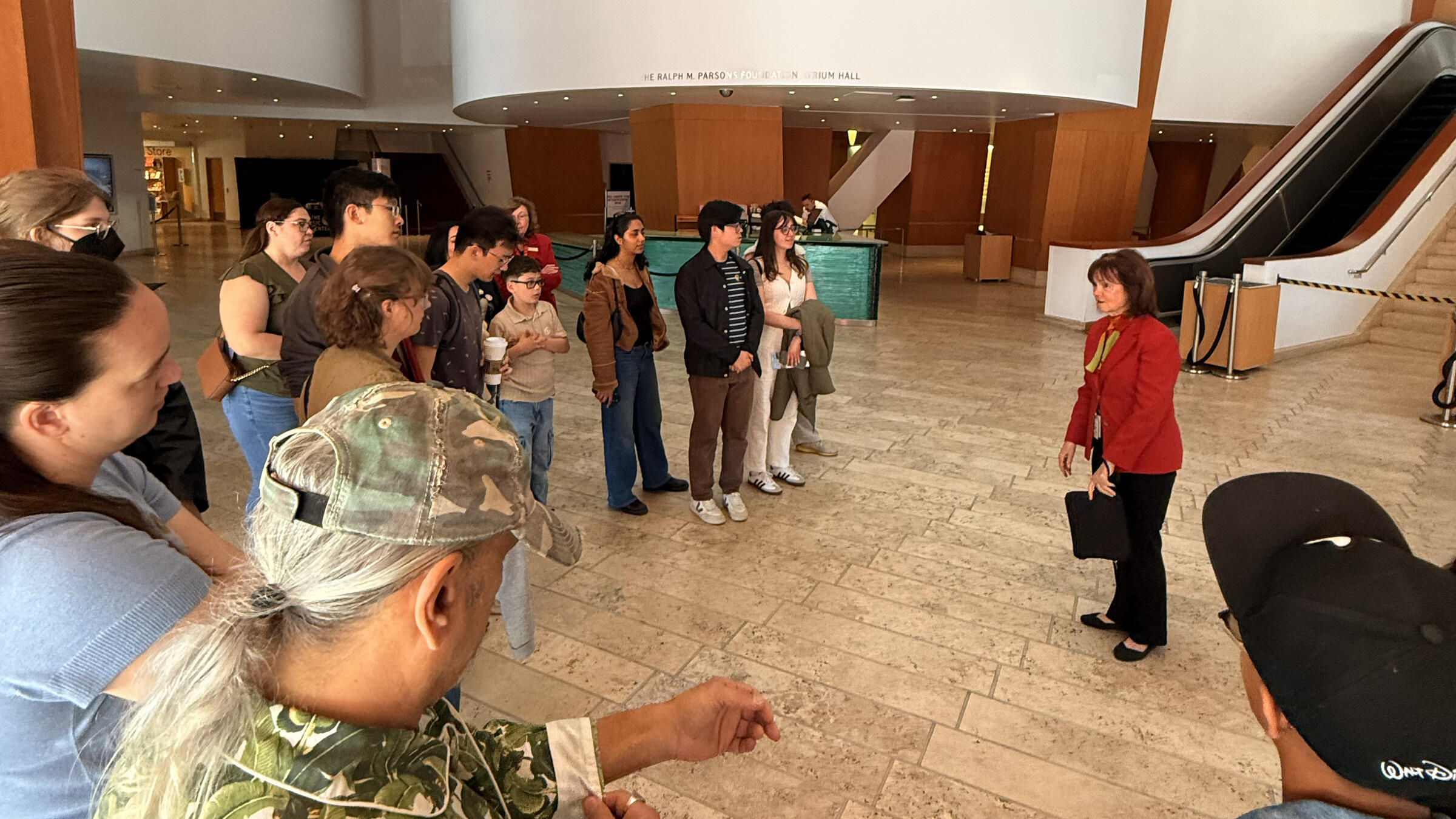 a group gathers for a tour in a theater lobby
