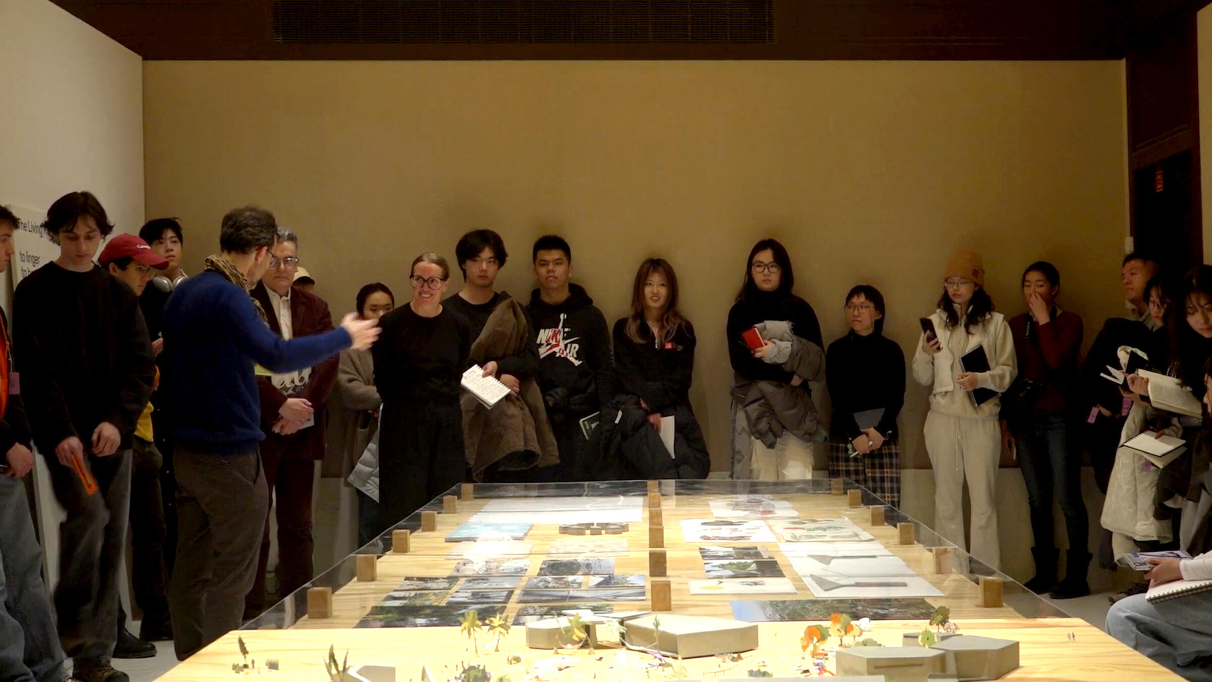 a group stands around a table in an exhibition