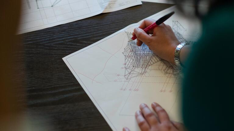 woman drafting architecture drawing