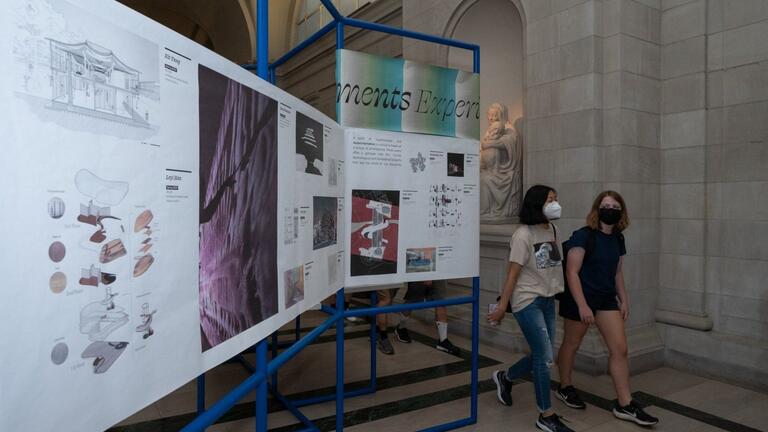 Students walk past display in the Great Hall