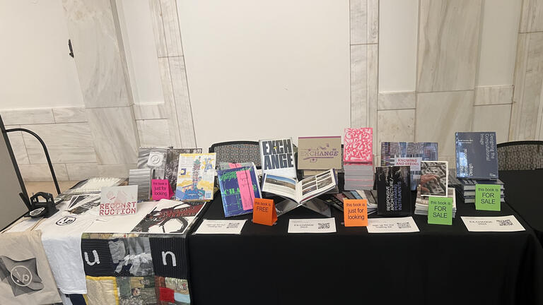 An exhibition table set up with publications on display from Carnegie Mellon Architecture.