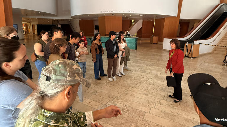 a group gathers for a tour in a theater lobby