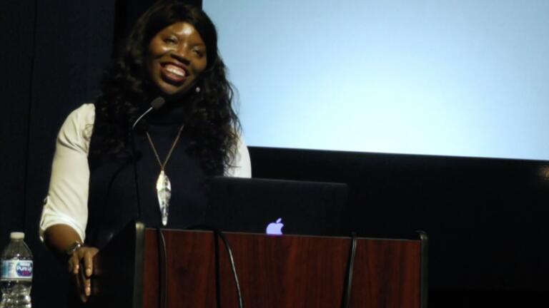 woman giving a lecture at a podium