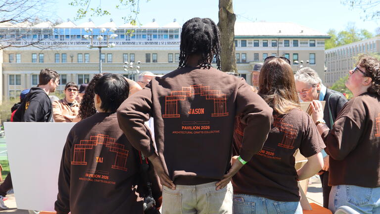 people facing away wearing matching sweatshirts