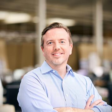 smiling person in a blue shirt