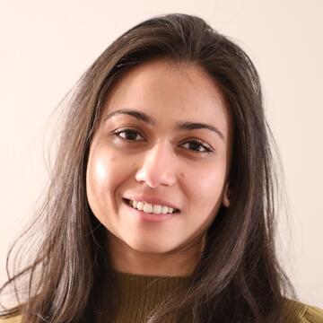 smiling person with long hair and a green shirt