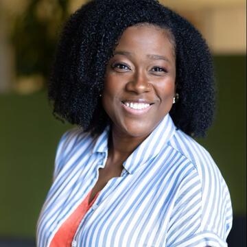 smiling person in blue and white striped collared shirt