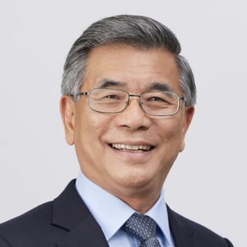 person wearing glasses and a suit and tie