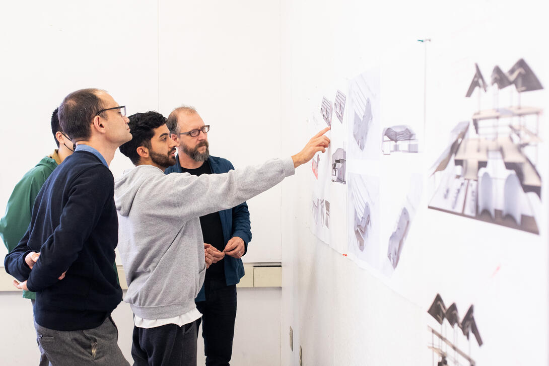 M.Arch students and professors discuss a pin-up