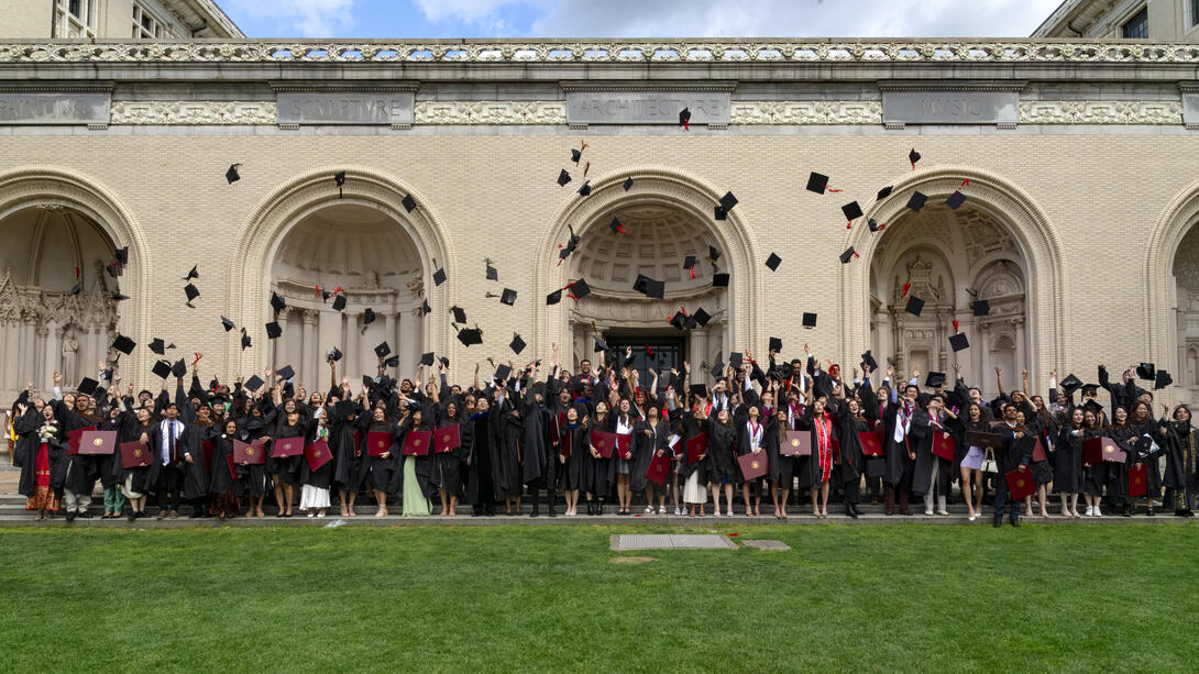 Carnegie Mellon Architecture graduates throw their caps in celebration on the lawn of the College of Fine Arts building. Credit: Long Q Hong graduates throw their caps in front of the College of Fine Arts
