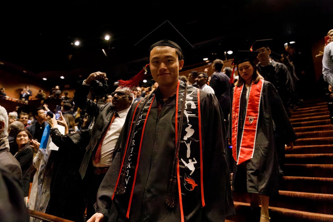 Carnegie Mellon Architecture graduates enter the theater for the Architecture diploma ceremony. Credit: Long Q Hong a student looks at the camera as they process into the theater for the graduation ceremony