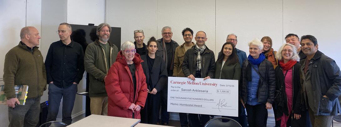 CFA Dean Mary Ellen Poole and CFA Senior Manager of Resource Operations Dan Barrett surprise Sarosh Anklesaria with the Henry Hornbostel Award.