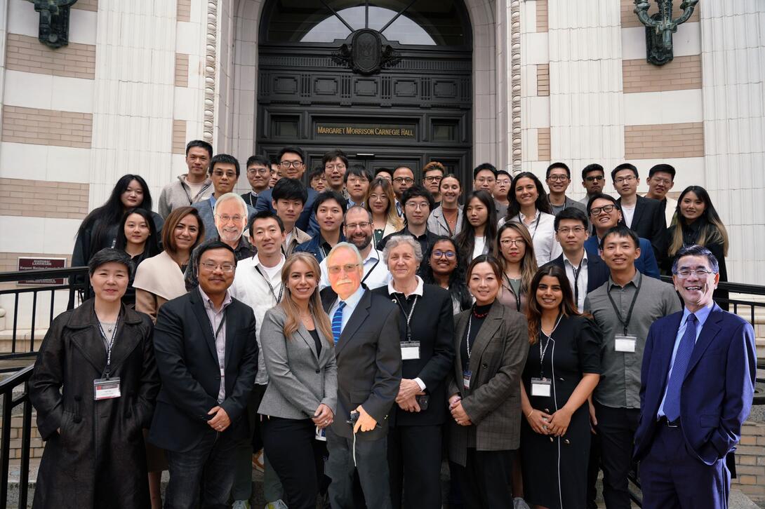 group poses for a photo outside in front of margaret morrison carnegie hall