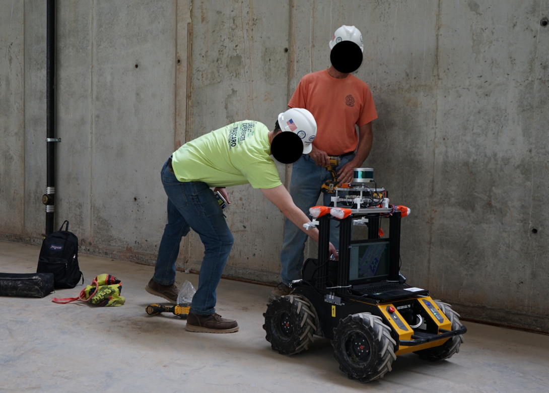 two workers with a small vehicle
