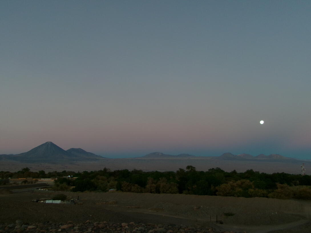 Village of San Pedro de Atacama at dusk. Licancabur volcano and the Andes Mountains in the background.